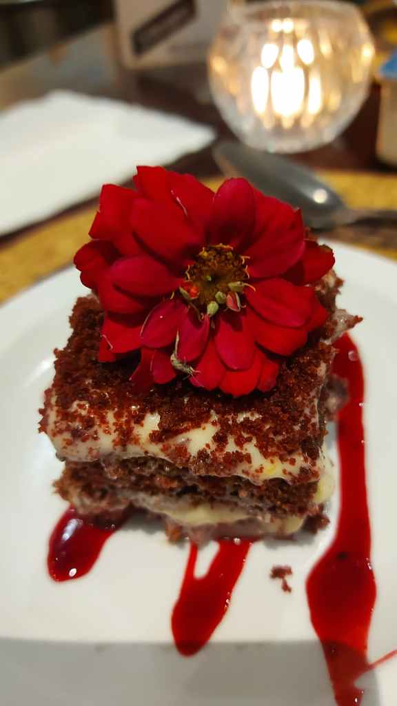 lovely red velvet cake with a red edible flower on top